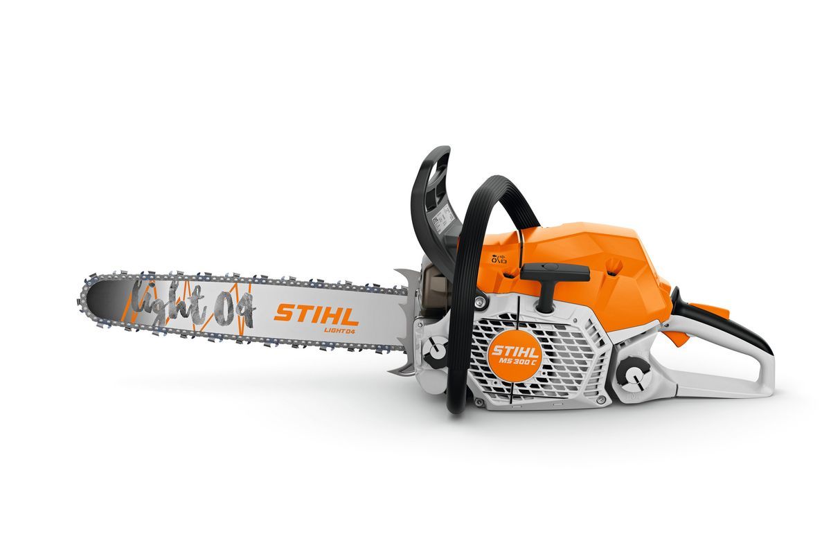 Orange och vit Stihl motorsåg liggande med svärd och kedja i sidovy